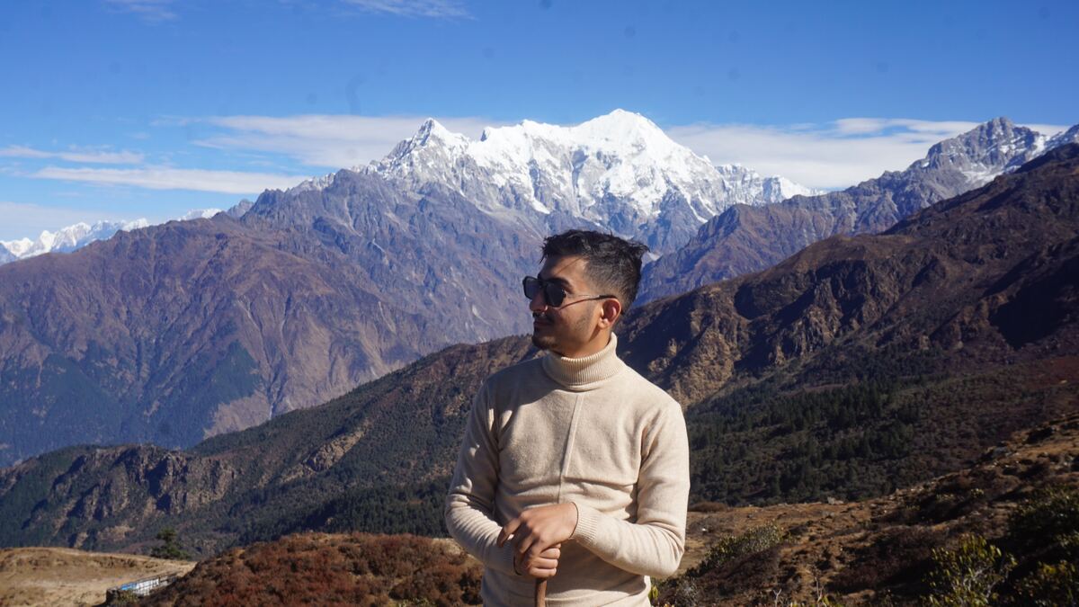 Utsav Paudel, Machine Learning Engineer from Nepal, with the Langtang mountain range behind him